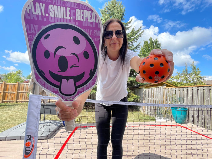 Female pickleball player on patio with paddle and SilentStrike